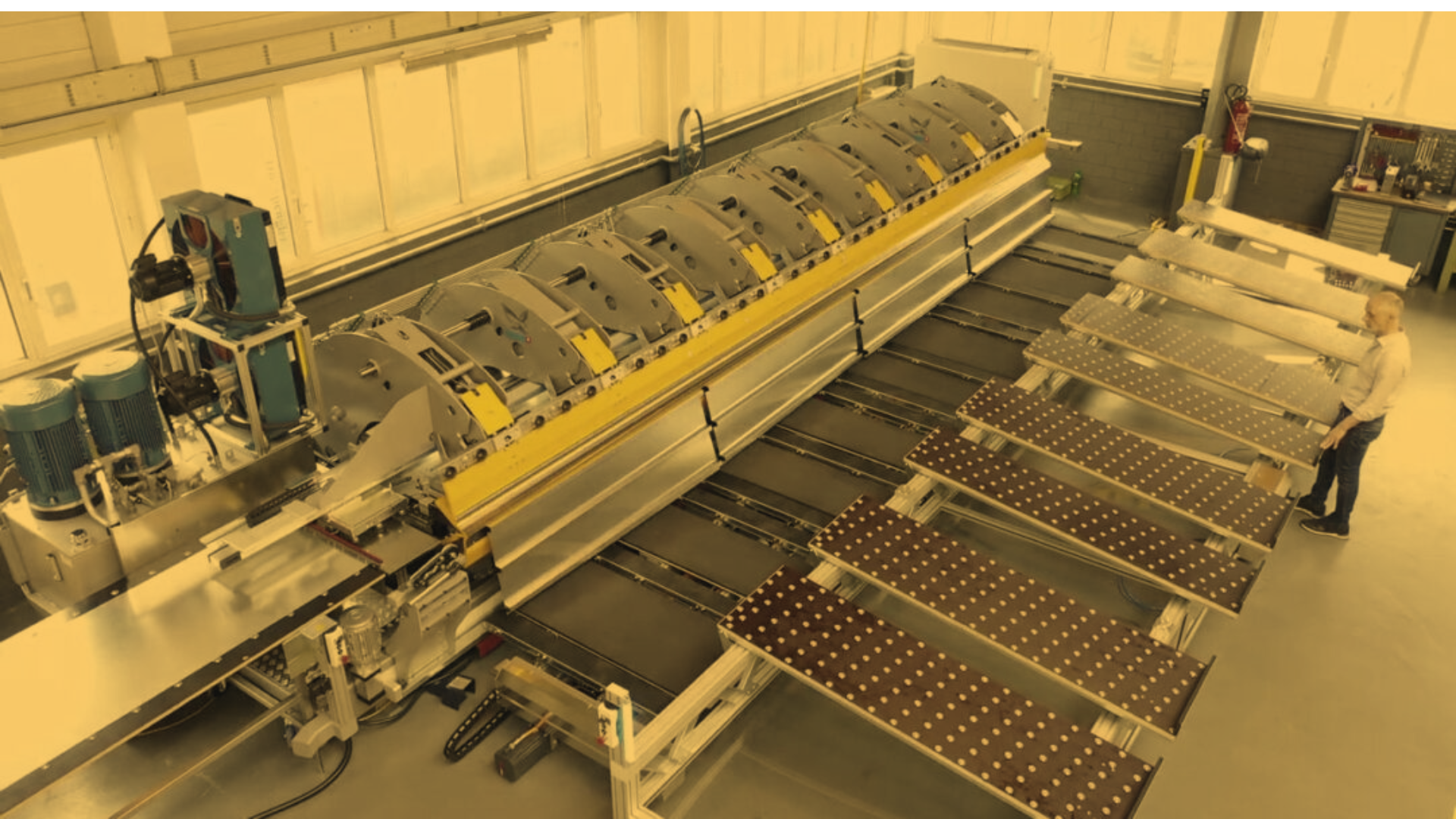 Thalmann TD machine with automation, displayed on a sleek white background, highlighting its advanced design and precision engineering for efficient metal folding.